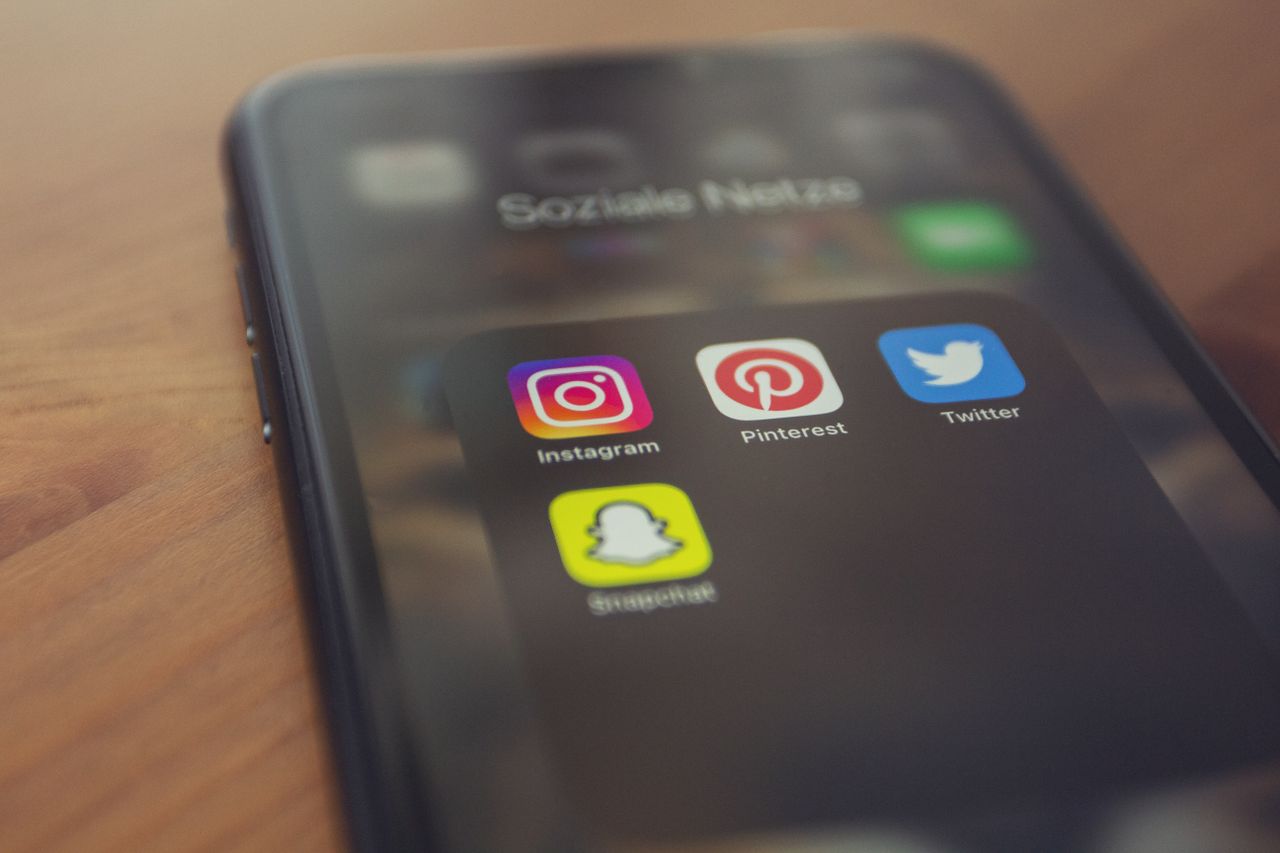 testimonials-img Smartphone displaying popular social media apps like Instagram, Pinterest, Twitter, and Snapchat.